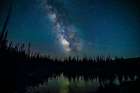 USA, Wyoming, Medicine Bow National Forest. Milky Way reflects in lake at night. Art Print